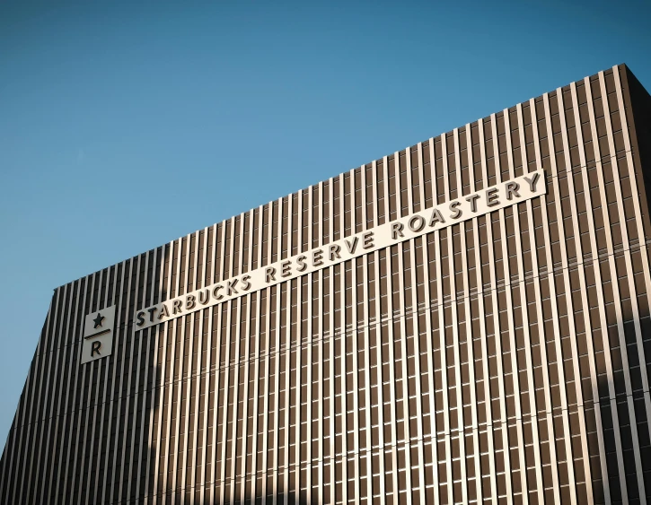 a tall building with a street sign on top of it, brutalism, rbc, starbucks, hi resolution, fan favorite