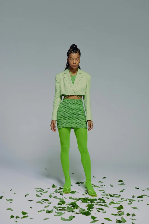 a woman standing in front of a pile of leaves, an album cover, inspired by Art Green, renaissance, neon colored suit, wearing crop top and miniskirt, off - white collection, lightgreen