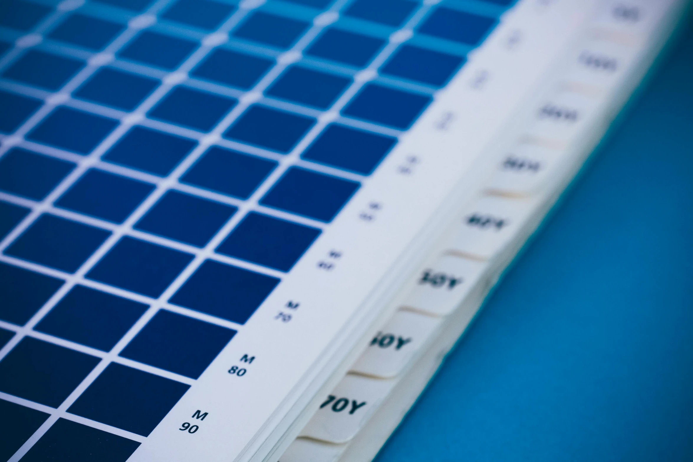 a close up of a tennis racket on a table, a silk screen, unsplash, color field, blue and white color palette, periodic table, pantone, 15081959 21121991 01012000 4k