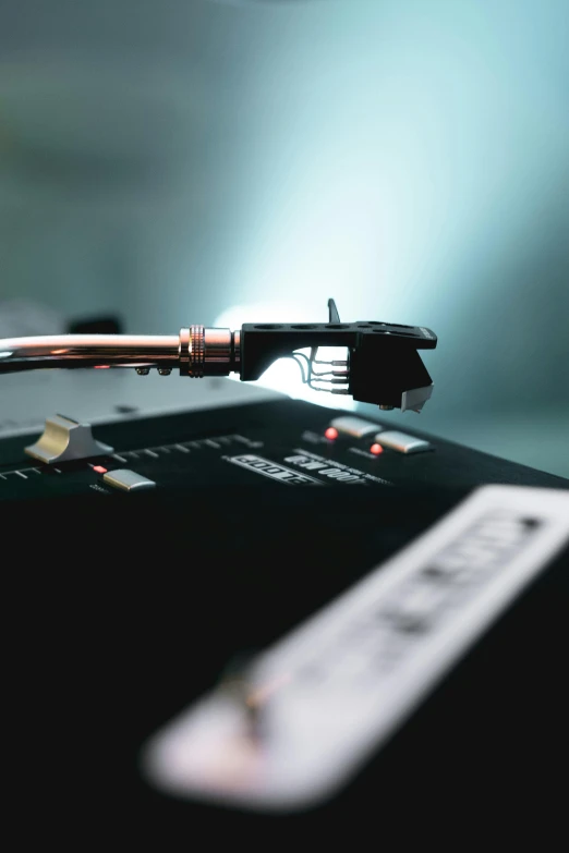 a close up of a record player's turntable, an album cover, by Niko Henrichon, unsplash, holding an activated lightsaber, integrated circuit, high quality photo, hyperreal highly detailed 8 k