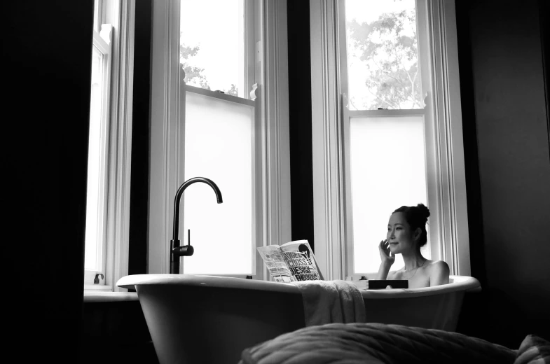 a little girl sitting in a bathtub in front of a window, a black and white photo, pexels, woman is sitting, magazine photo, luxurious environment, lucy liu portrait