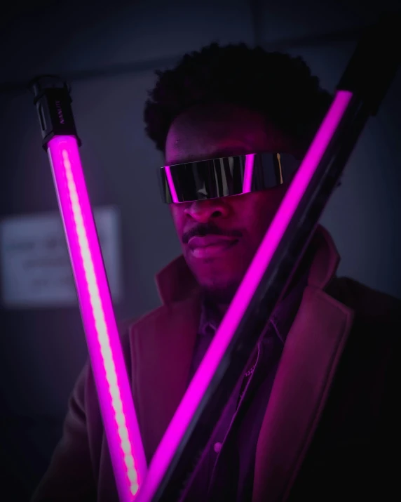 a man with a pair of neon sticks in his hand, unsplash, afrofuturism, an imperial agent from star wars, bisexual lighting, cyber goggles, with large sword