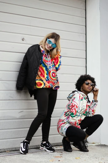 a couple of women standing next to each other, trending on unsplash, toyism, colourful clothing, colorful]”, street wears, funkadelic