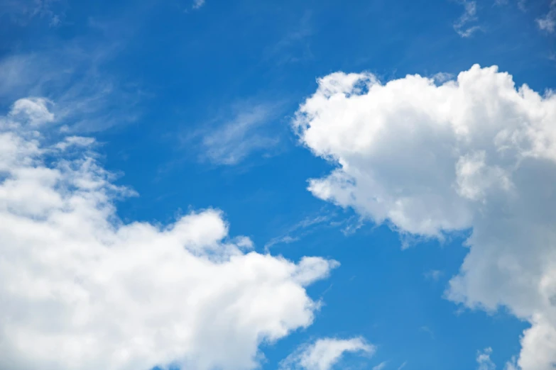 a plane flying through a cloudy blue sky, unsplash, romanticism, prismatic cumulus clouds, high quality product image”, low angle photo, cloudless-crear-sky