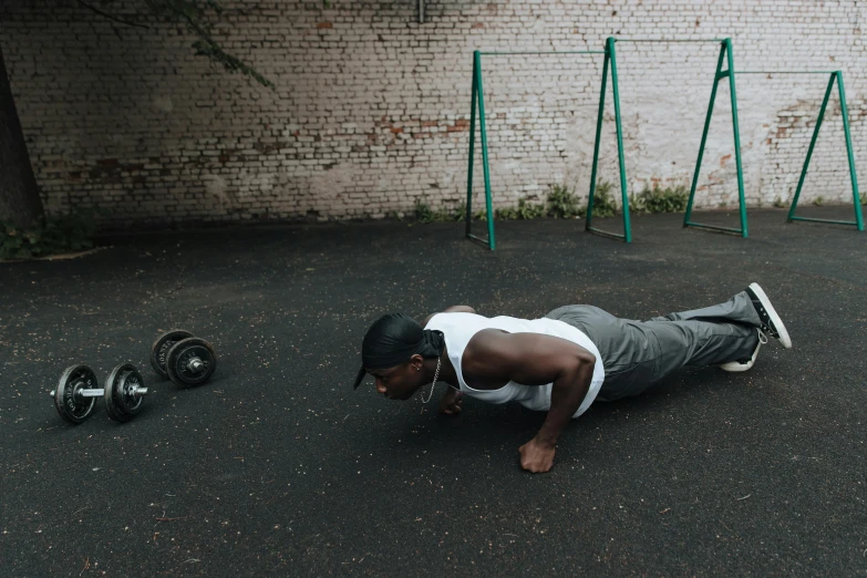 a man doing push ups in a parking lot, pexels contest winner, man is with black skin, profile image, background image, in the yard