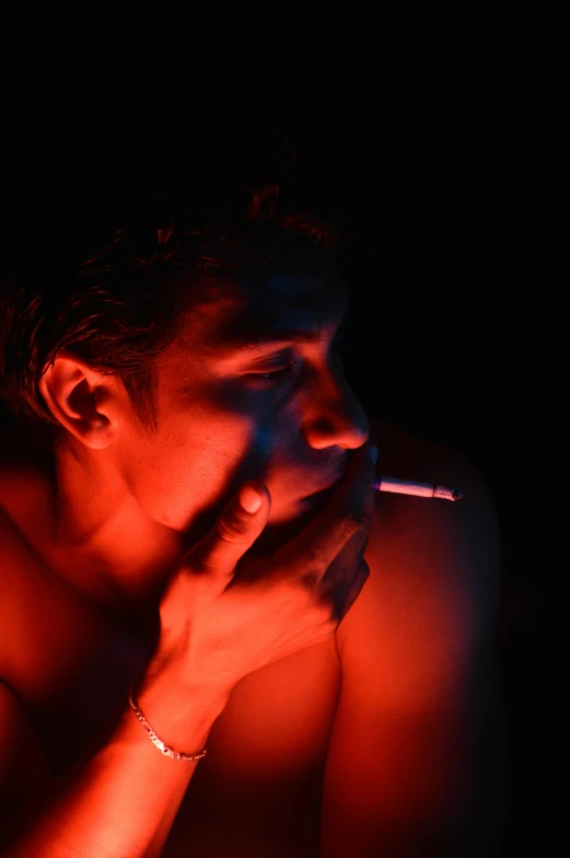 a man smoking a cigarette in the dark, an album cover, inspired by Nan Goldin, pexels, visual art, red glowing skin, ilustration, ganja, red monochrome