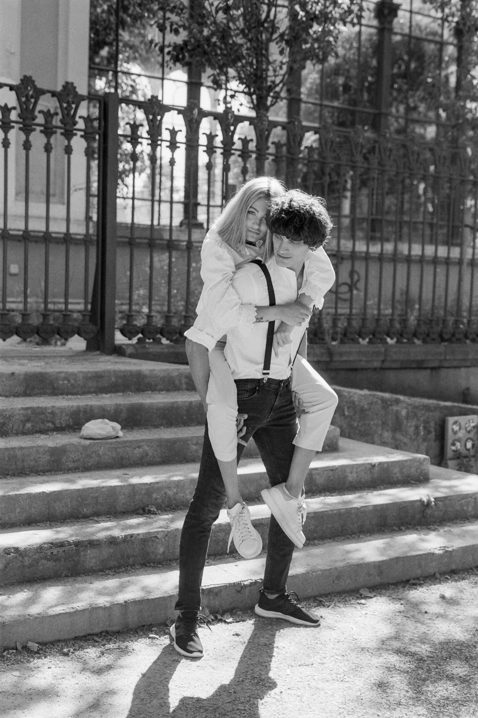 a black and white photo of a man carrying a woman, a black and white photo, tumblr, petra collins, riccardo scamarcio, in sunny weather, 15081959 21121991 01012000 4k