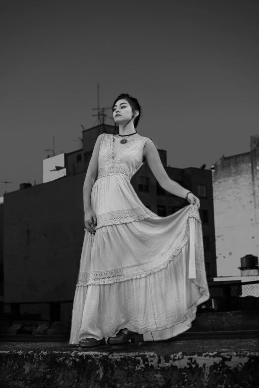 a black and white photo of a woman in a dress, pexels contest winner, on rooftop, isabela moner, jingna zhang, vintage vibe