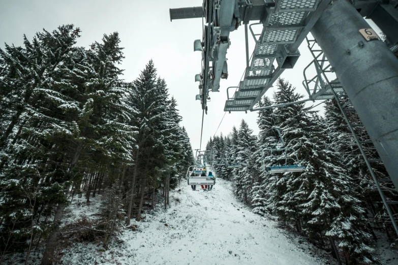 a group of people riding on top of a ski lift, snowy forest, high quality product image”, maintenance photo, shot on sony a 7