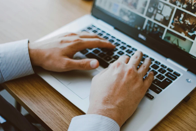 a close up of a person typing on a laptop, pexels, realistic »