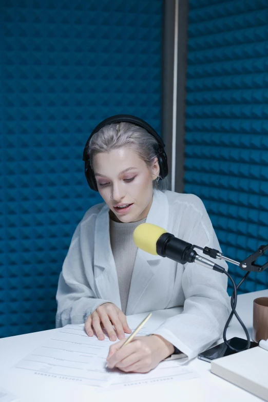 a woman sitting at a table in front of a microphone, eva elfie, radio signals, anton fedeev, studio photoshoot