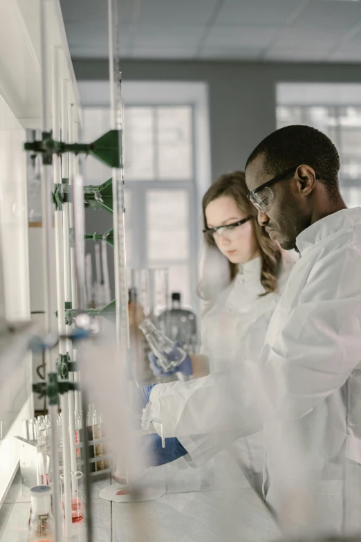 a couple of people standing next to each other in a lab, trending on unsplash, analytical art, panel, white, plating, high quality photo