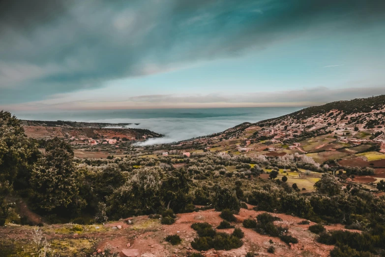 a view of the ocean from the top of a hill, unsplash contest winner, les nabis, moroccan, mauve and cyan, bird\'s eye view, dramatic sky and landscape