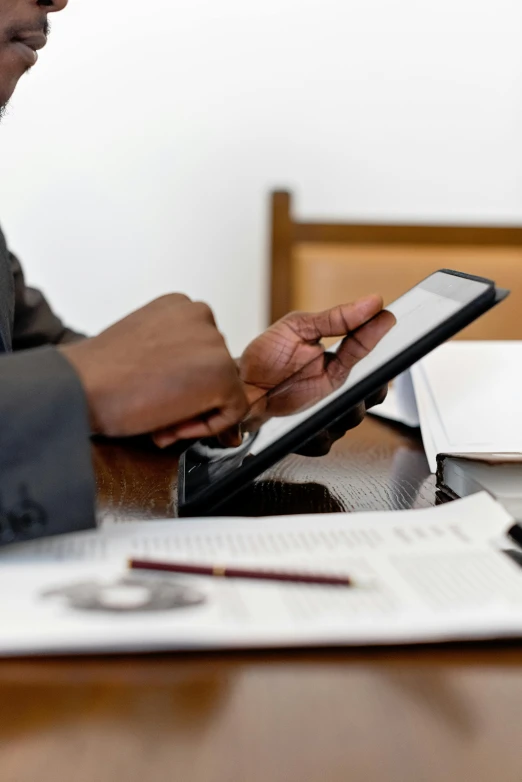 a man sitting at a table using a tablet computer, zoomed in, digital image, thumbnail