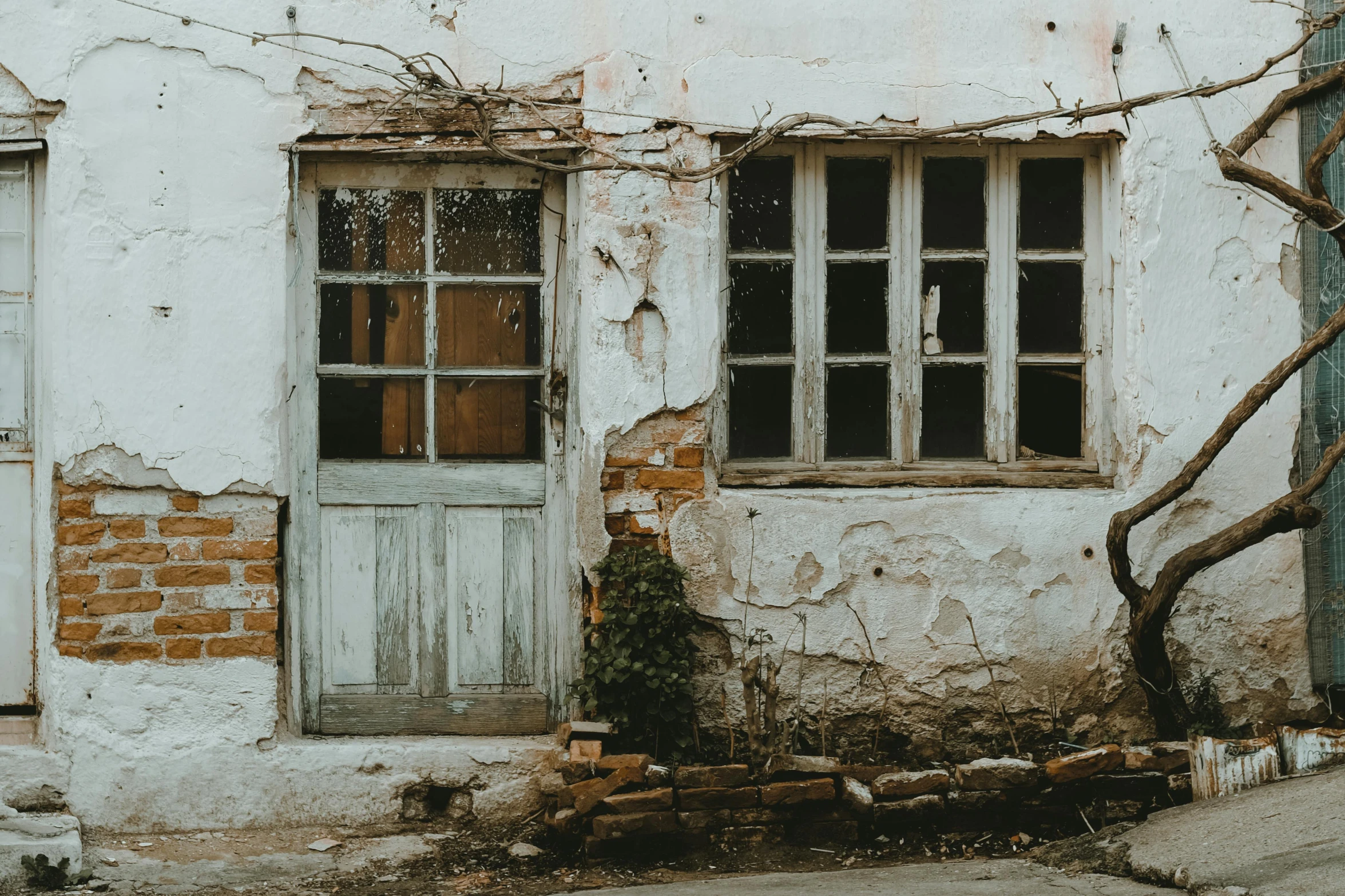 a red fire hydrant sitting in front of a building, a picture, pexels contest winner, renaissance, abandoned cottage, leaning on door, ai weiwei and gregory crewdson, windows and walls :5