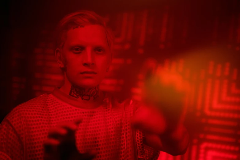 a man standing in front of a red light, cybersyn, eleven/millie bobbie brown, film still from 'thor', dj at a party