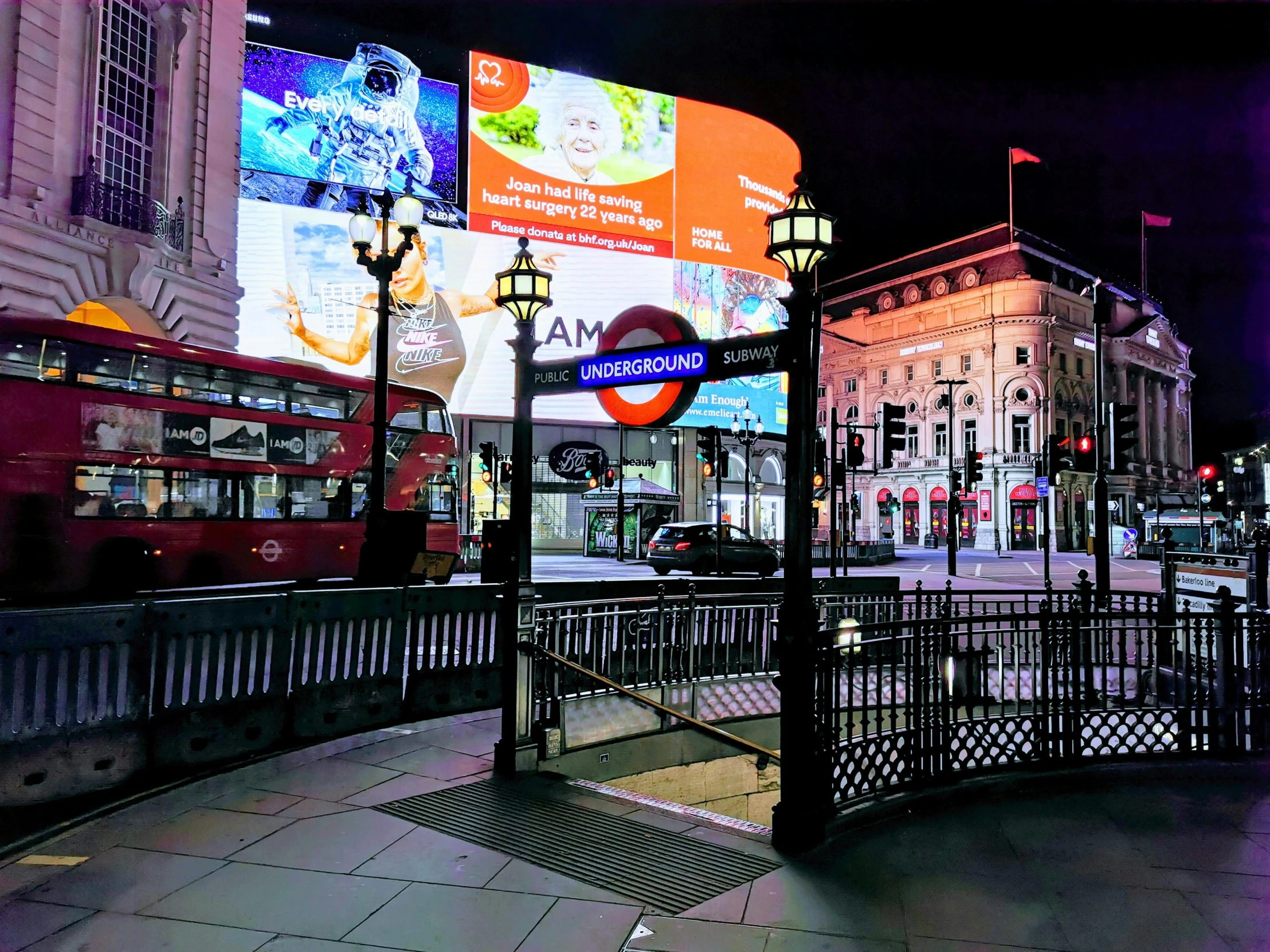 a double decker bus on a city street at night, an album cover, inspired by Thomas Struth, pexels contest winner, hyperrealism, london underground tube station, large commercial led screens, random circular platforms, in