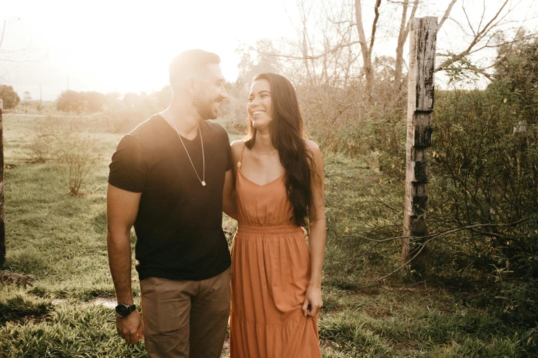 a man and woman standing next to each other in a field, pexels contest winner, hispanic, background image, joanna gaines, warm glow