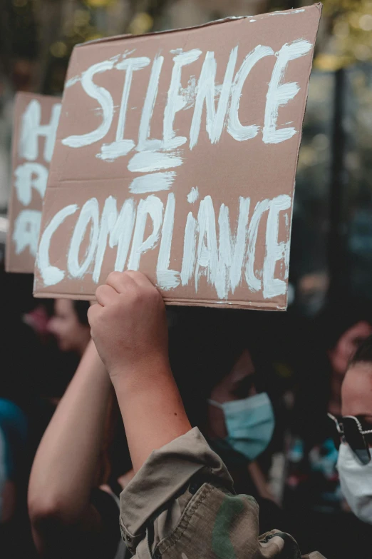 a person holding a sign in front of a crowd, silence, high complexity, biolusence, thumbnail