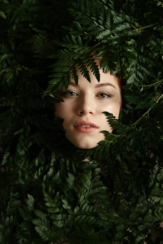 a woman with green leaves covering her face, an album cover, inspired by Elsa Bleda, trending on pexels, renaissance, ferns, portrait of barbara palvin, sydney sweeney, headshot profile picture