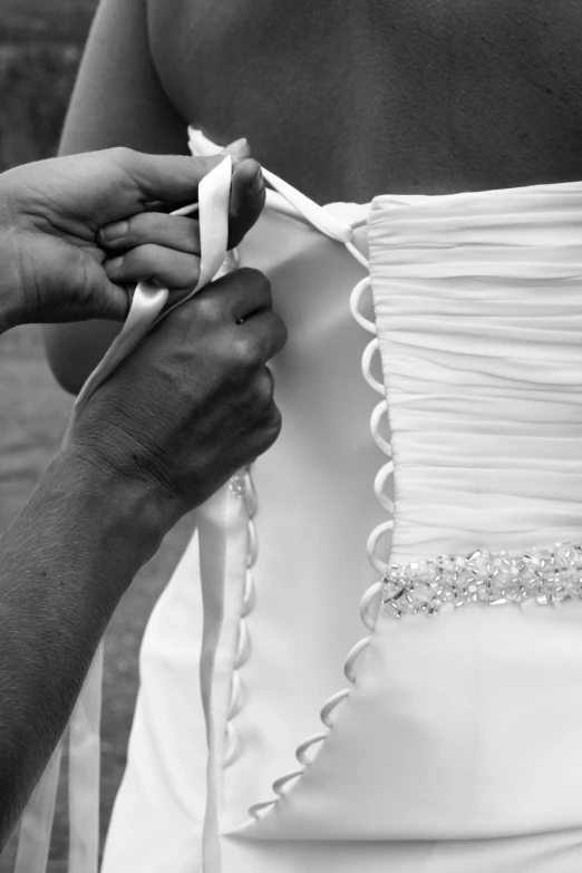 a black and white photo of a person tying a wedding dress, uploaded, bright ”, information, version 3