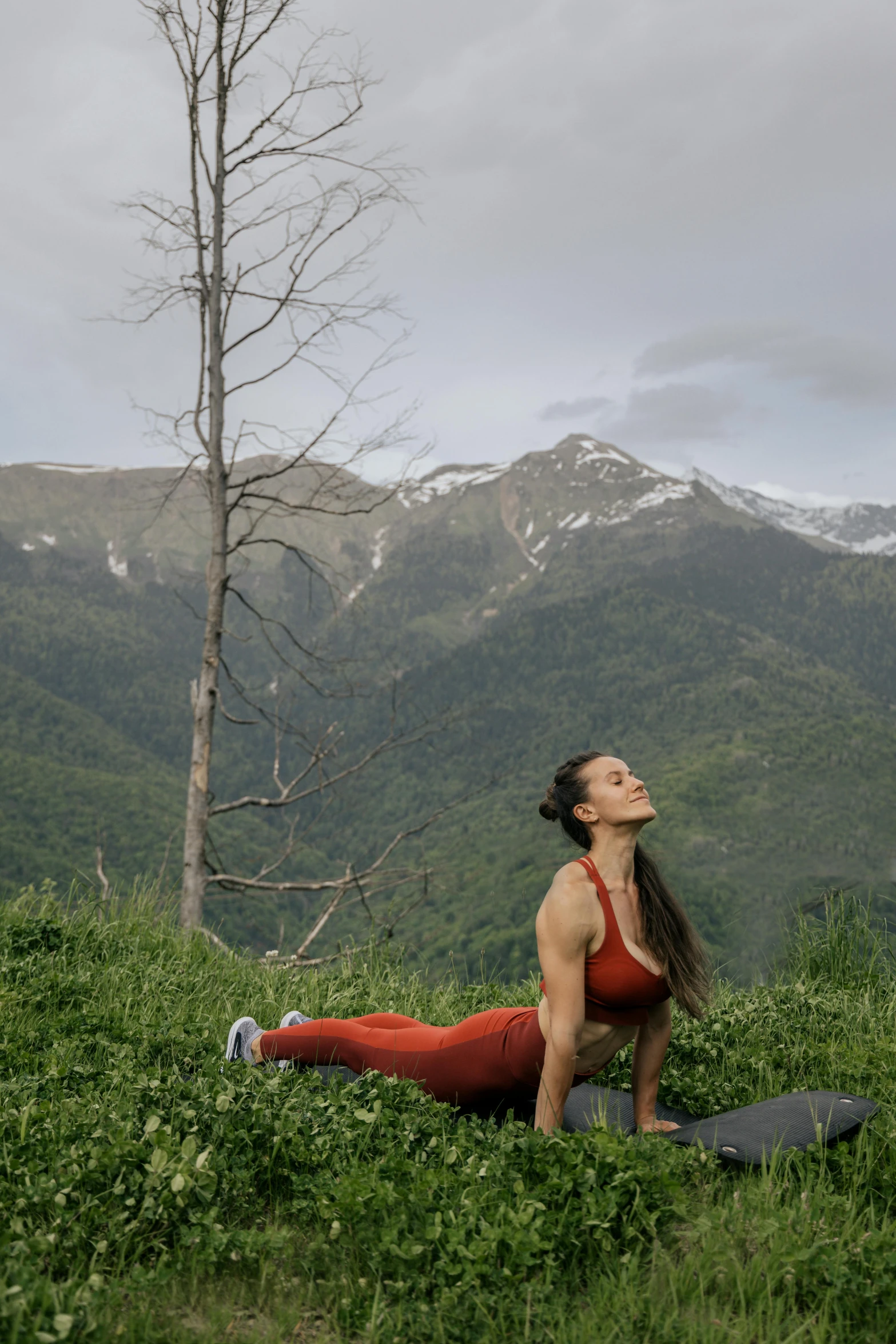 a woman doing a yoga pose in the mountains, by Emma Andijewska, renaissance, russia, cottagecore!! fitness body, profile image, india