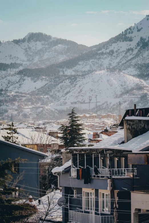 a view of a town with a mountain in the background, by Muggur, pexels contest winner, heavy winter aesthetics, tiled roofs, seen from outside, today\'s featured photograph 4k