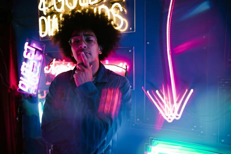 a man standing in front of a neon sign, pexels contest winner, ashteroth, light skin, light room, with a cool pose