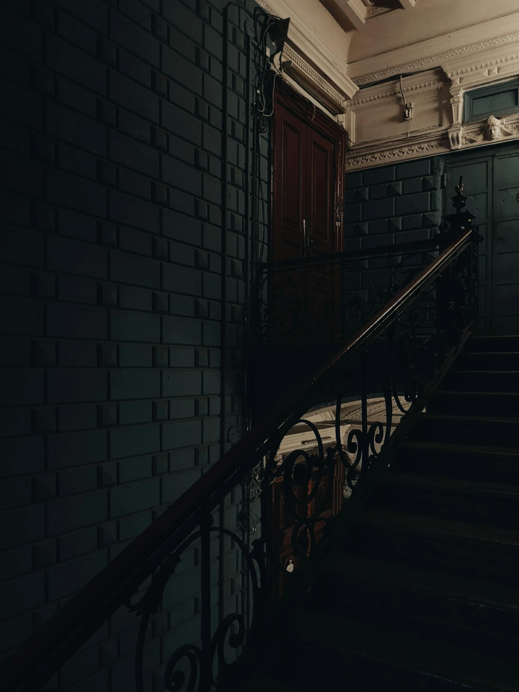 a black and white photo of a staircase in a building, inspired by Elsa Bleda, unsplash contest winner, art nouveau, dark teal lighting, spooky mansion, ignant, an escape room in a small