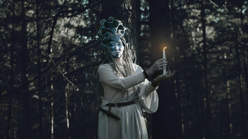 a woman dressed in white holding a candle in a forest, unsplash contest winner, fantasy art, elf with blue skin, horned god, photograph taken in 2 0 2 0, avatar image