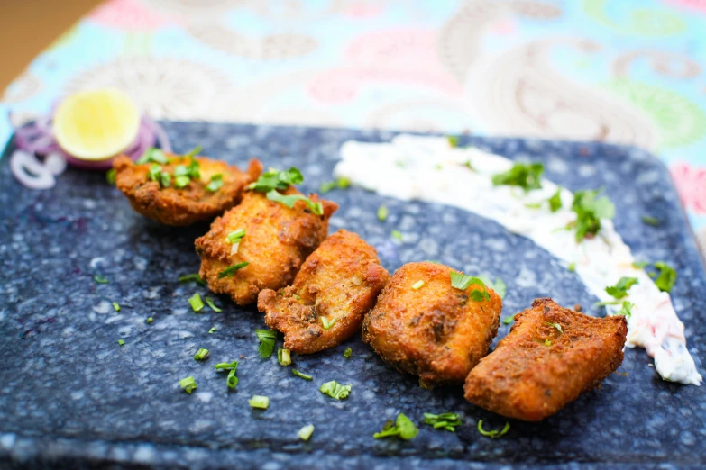 a close up of a plate of food on a table, inspired by Jitish Kallat, wings spread, profile image, deep fried, thumbnail