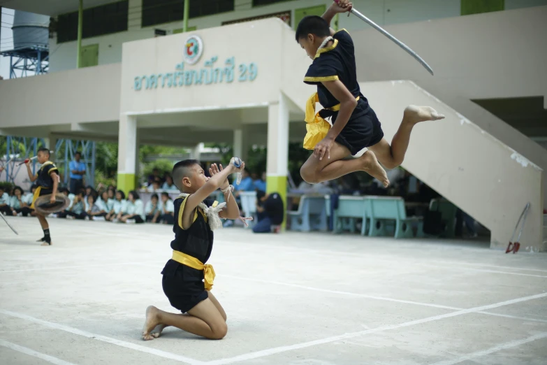 a couple of people that are jumping in the air, pexels contest winner, dau-al-set, school class, thailand, sword fighting, slide show