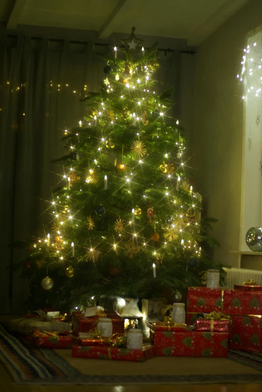 a christmas tree in the corner of a living room, happening, very atmospheric lighting, looking towards the camera, taken from the high street, close-up!!!!!