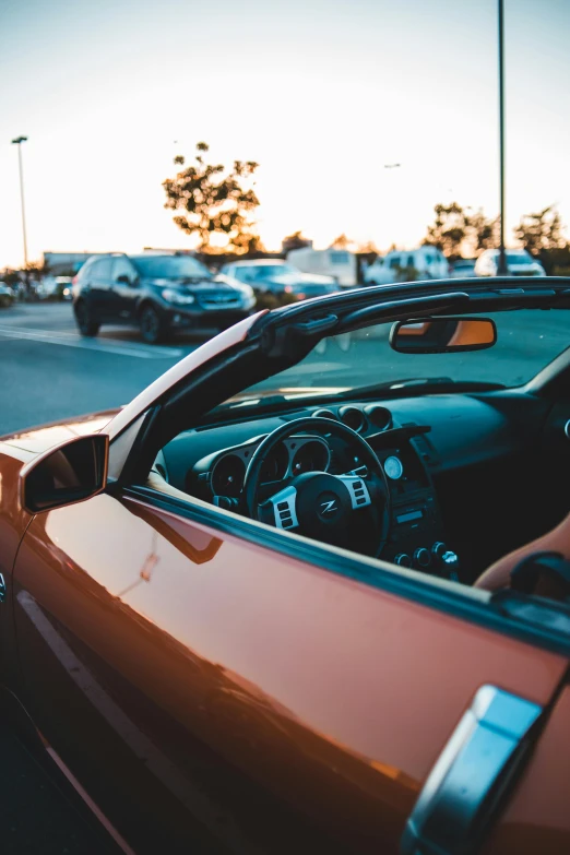 a red sports car parked on the side of the road, pexels contest winner, inside of a car, orange tint, open top, thumbnail