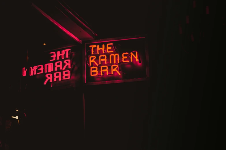a couple of signs that are on the side of a building, an album cover, by Dan Frazier, unsplash contest winner, sumatraism, dimly lit dive bar, ramen, rammstein, 1970s photo