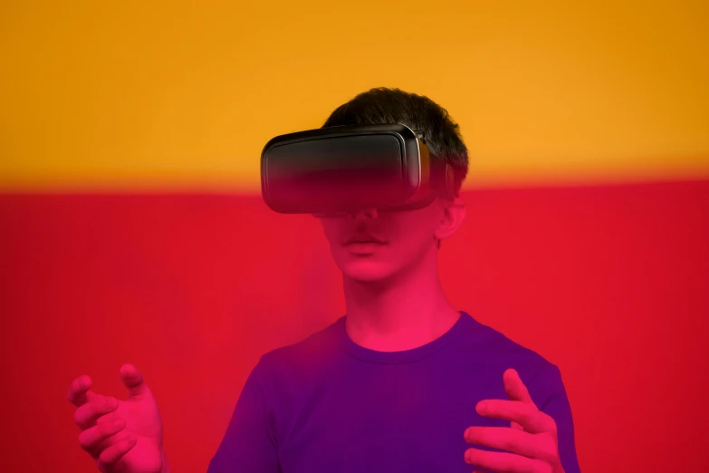a man standing in front of a red and yellow wall, a hologram, pexels, interactive art, virtual reality headset, teenage boy, dark visor covering top of face, photograph of 3d ios room