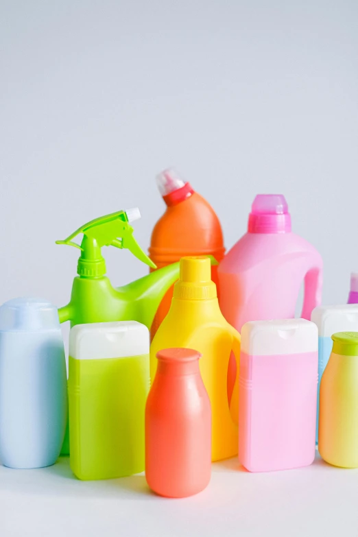 a group of plastic bottles sitting next to each other, detailed product image, colorful mold, sprays, uncluttered