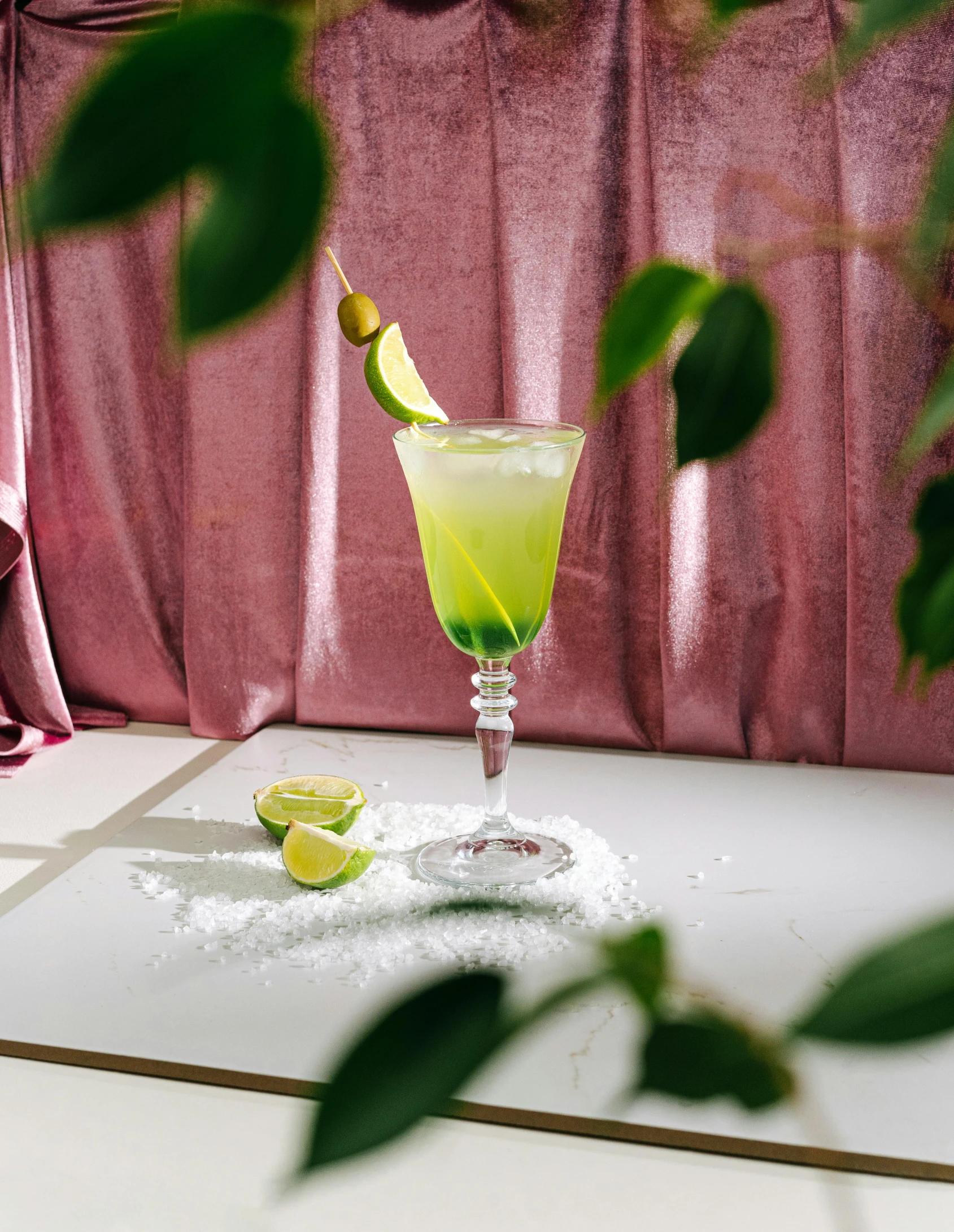 a close up of a drink in a glass on a table, a still life, inspired by Carlo Martini, unsplash, lime green, the non-binary deity of spring, background image, cuban setting