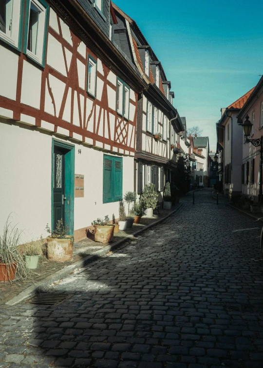 a cobblestone street in an old european town, by Tobias Stimmer, pexels contest winner, romanesque, medium format. soft light, lower saxony, 4 k cinematic still, white