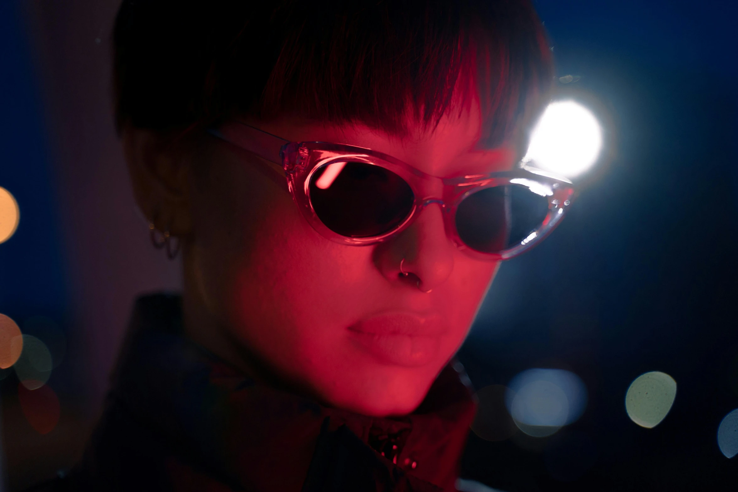 a close up of a person wearing sunglasses at night, inspired by Elsa Bleda, trending on pexels, bauhaus, volumetric lighting. red, ashteroth, kiko mizuhara, multiple lights