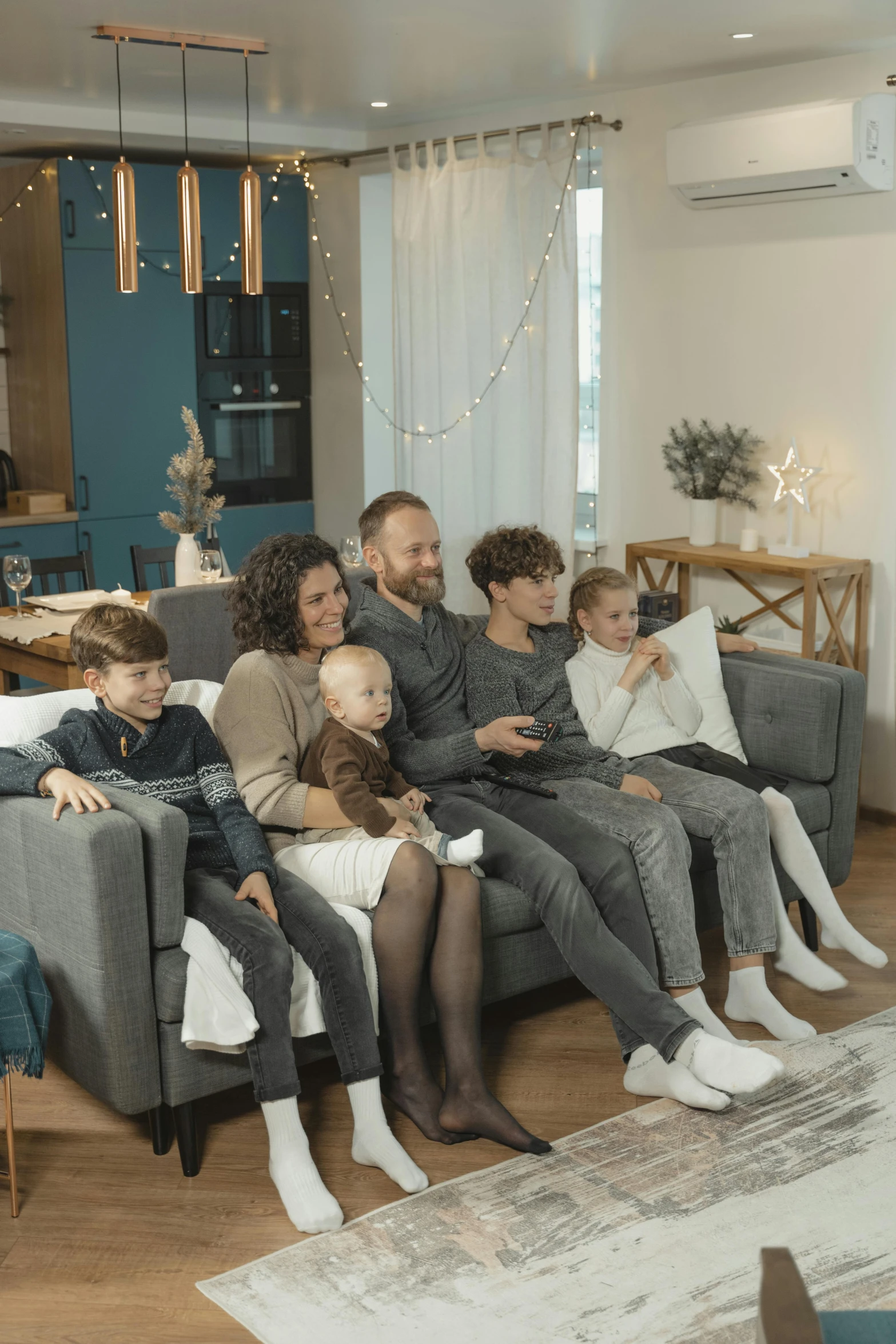 a group of people sitting on a couch in a living room, holiday season, incredible quality, parents watching, scandinavian