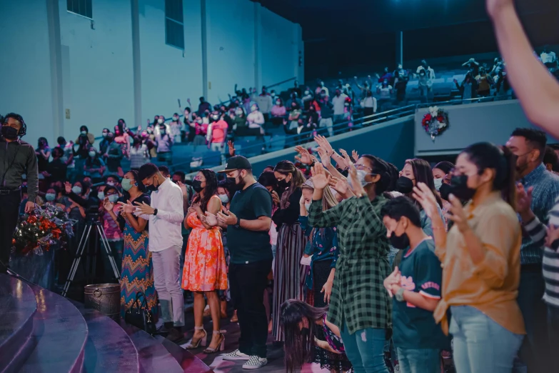 a group of people standing on top of a stage, praying, background image, instagram post, the blessed aisles