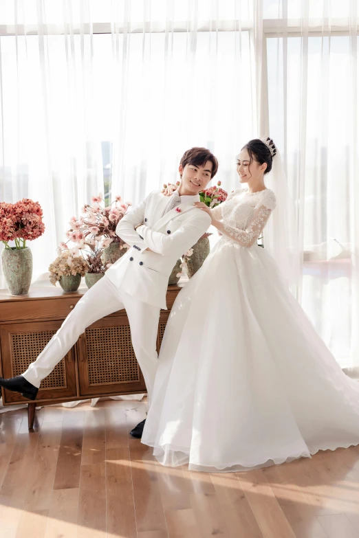 a man in a white suit and a woman in a white dress, inspired by Kim Jeong-hui, doing an elegant pose, wearing a wedding dress, official store photo, square