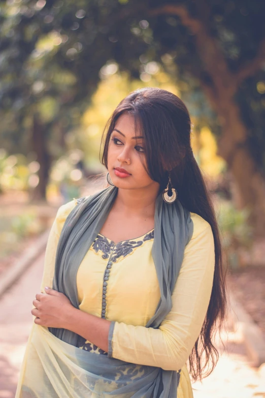 a woman in a yellow dress posing for a picture, pexels contest winner, hurufiyya, assamese, grayish, flirting, square