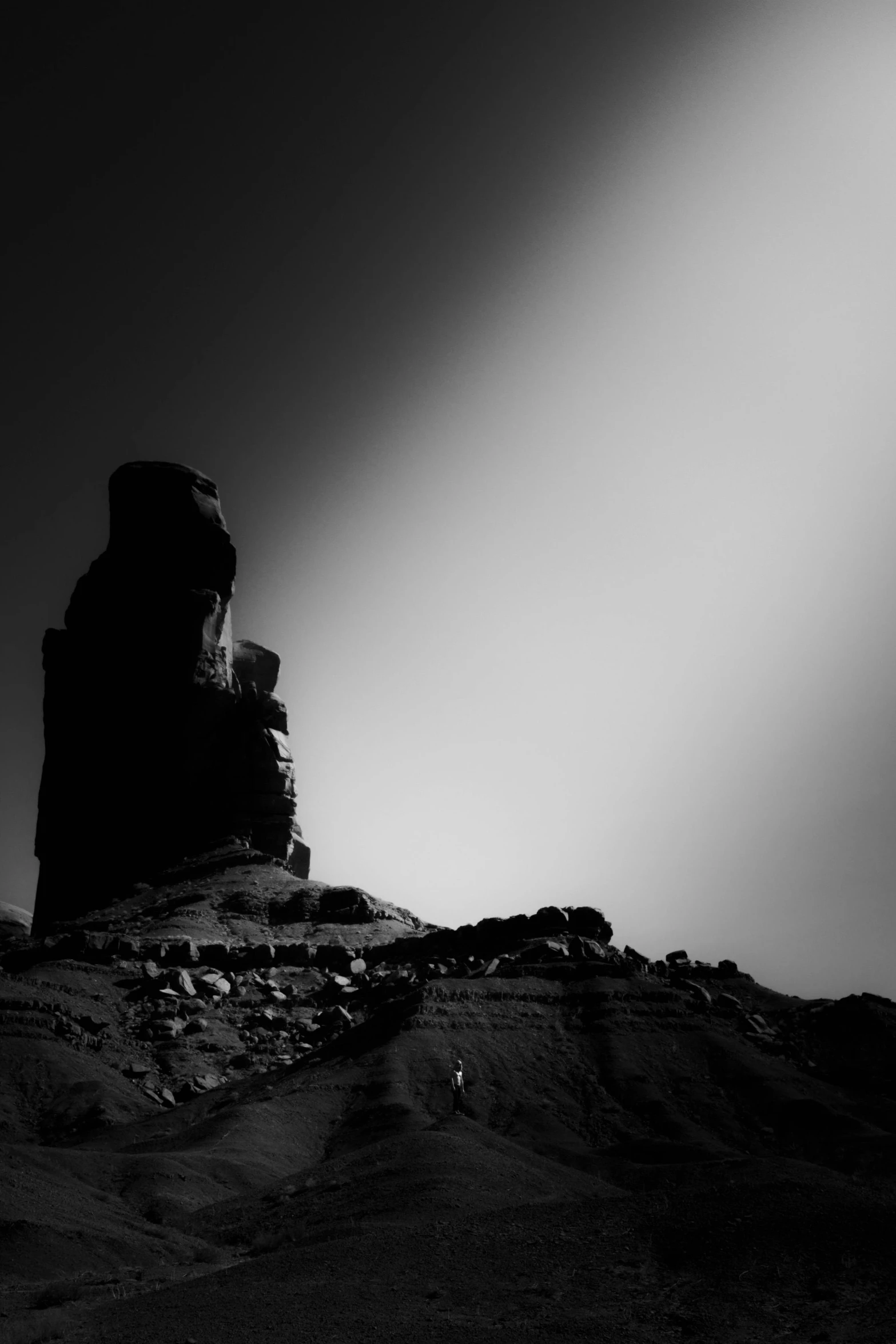 a black and white photo of a rock formation, a black and white photo, unsplash, conceptual art, sunset on mars, sunflare, ello, ziggurat