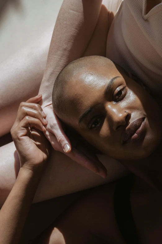 a man laying on top of a woman on a bed, by Cosmo Alexander, trending on pexels, renaissance, shaved head, portrait of ororo munroe, nonbinary model, intimately holding close