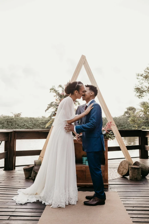 a man and woman standing next to each other on a dock, by Robbie Trevino, pyramid surrounded with greenery, celebration, mangrove trees, making out