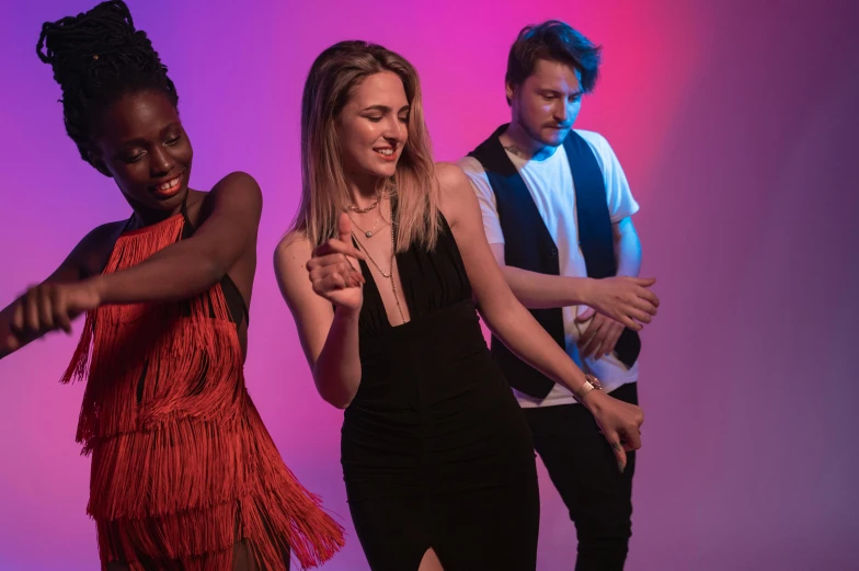 a group of young people standing next to each other, an album cover, by Arabella Rankin, pexels contest winner, happening, salsa dancing, glowing with colored light, studio shoot, mid-twenties