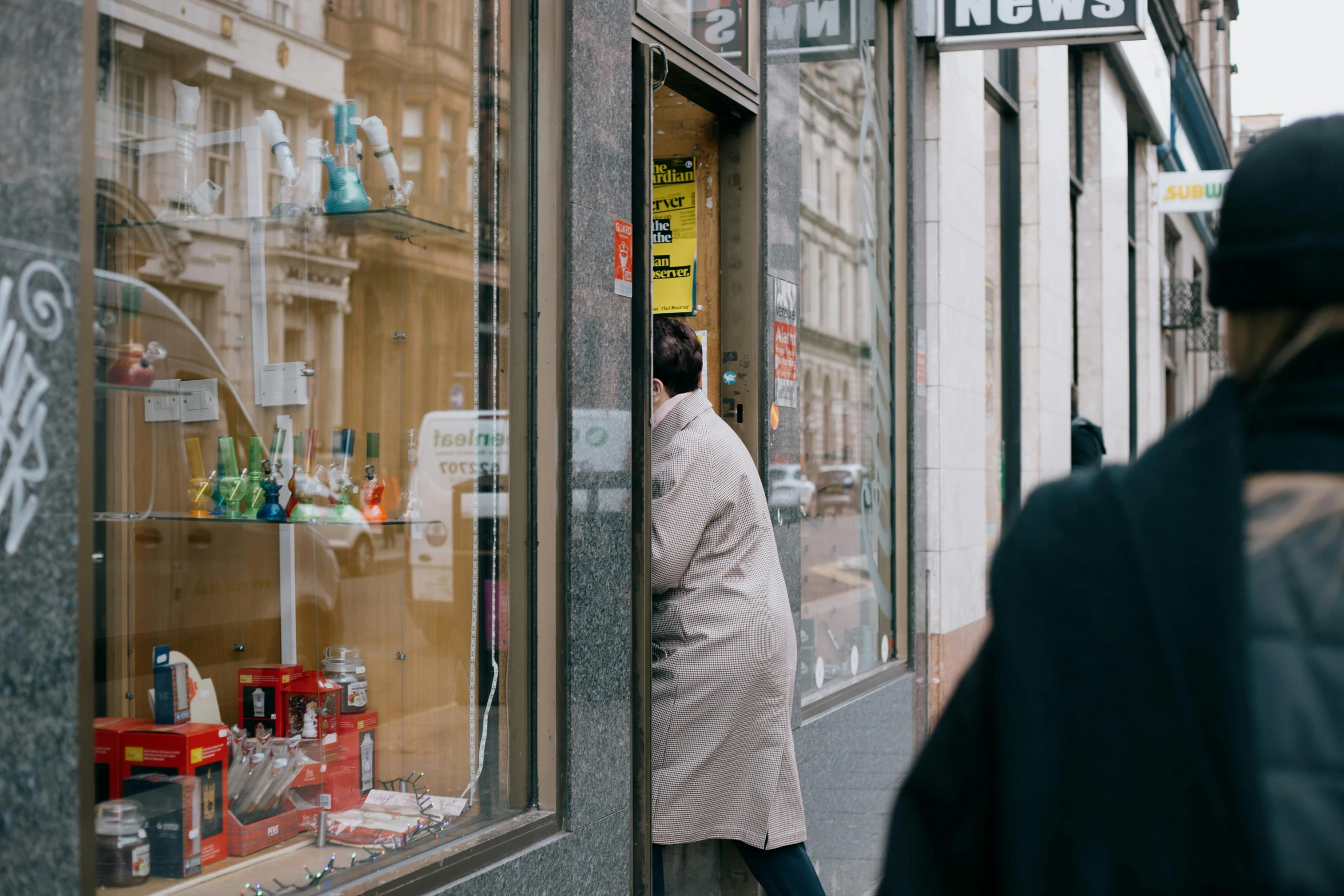 a person standing in front of a store window, pexels contest winner, private press, looking around a corner, glasgow, news report, neo norilsk