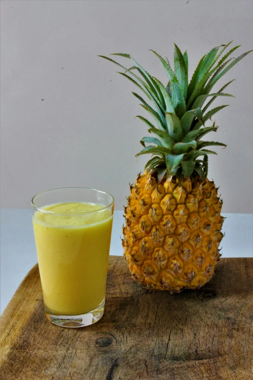 a pineapple next to a glass of orange juice, a portrait, flickr, vanilla smoothie explosion, spanish, 0, recipe